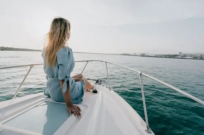 Free Photo Of A Woman Sitting On The Back Of A Boat Looking Out To Sea 1024x683