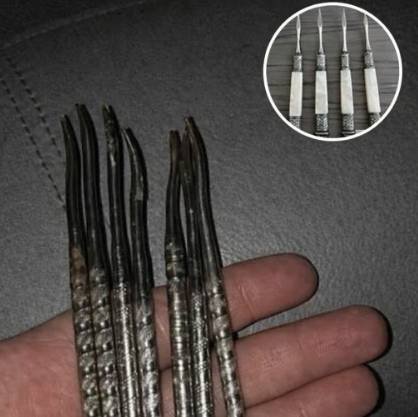 A collection of vintage metal nut picks in a small bowl.