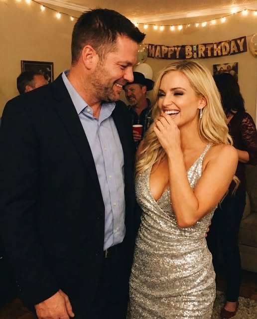 Woman standing calmly at her surprise party after discovering her husband arrived holding another woman’s hand.