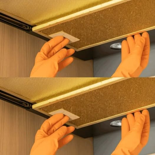 A clean, shiny kitchen hood with a cloth and bowl of salt, vinegar, and hot water nearby, symbolizing an easy and effective cleaning method.