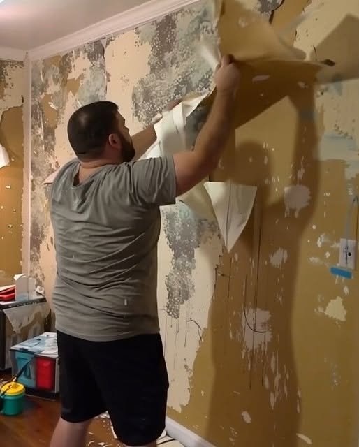 Mother and children redecorating home after emotional divorce and damaged walls