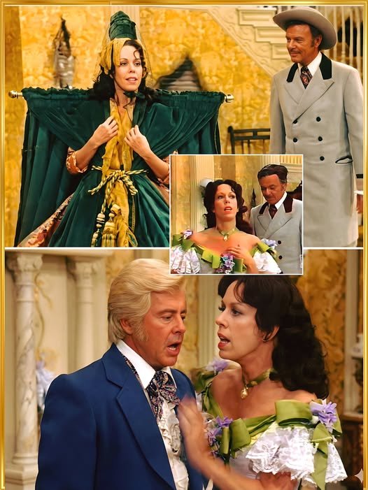  Carol Burnett descends a staircase in a green velvet curtain draped like a gown, the curtain rod visible across her shoulders, as the audience laughs hysterically in the background.