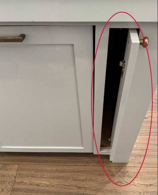 Narrow kitchen cabinet pull-out storage unit used for spices and utensils in tight spaces