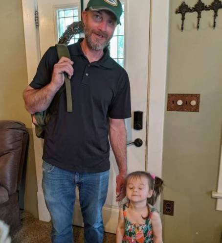 Little girl waiting by the door for her father in an emotional moment