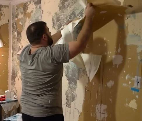 Empty walls after torn wallpaper symbolizing a fresh start after divorce