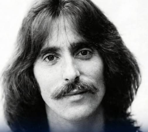 Chuck Negron performing on stage as lead singer of Three Dog Night during a live concert