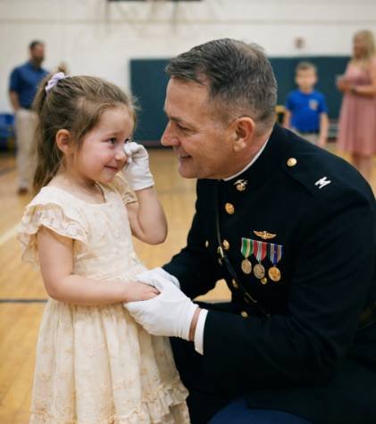 A father-daughter dance scene with Marines arriving to support a young girl holding a letter in an emotional moment