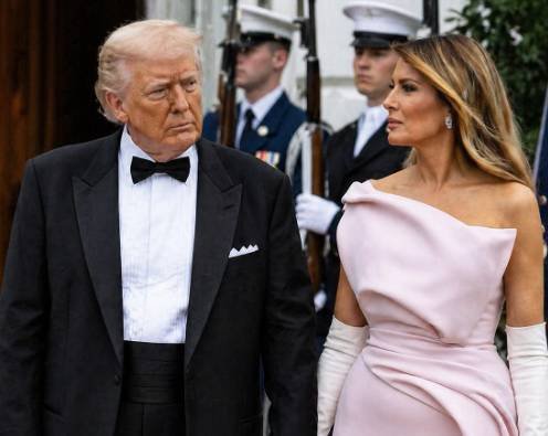 Melania Trump wearing a pink gown at a White House state dinner event with formal attire