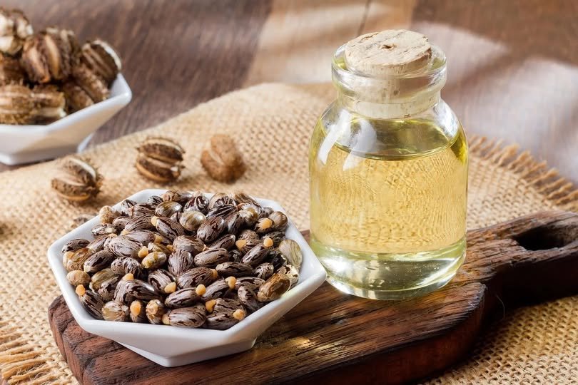 Bottle of castor oil with natural skincare ingredients and healthy glowing skin concept