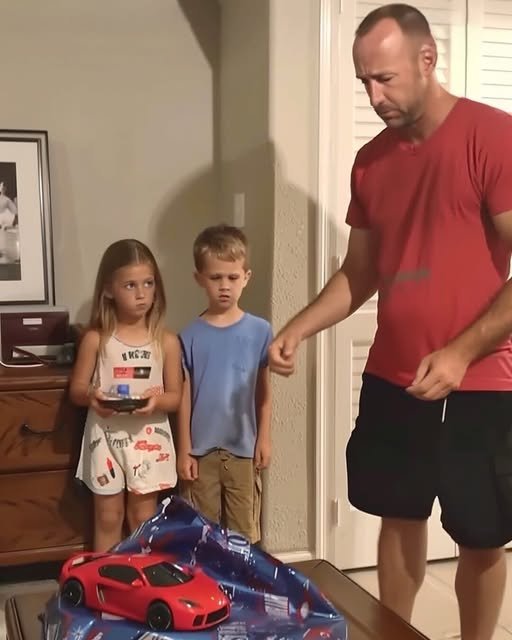 A man kneels beside his children, his expression a mix of regret and love, as he hands them back their toys, symbolizing a new beginning.