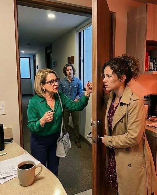 Woman standing calmly at her apartment door confronting her ex-mother-in-law during a tense post-divorce moment.